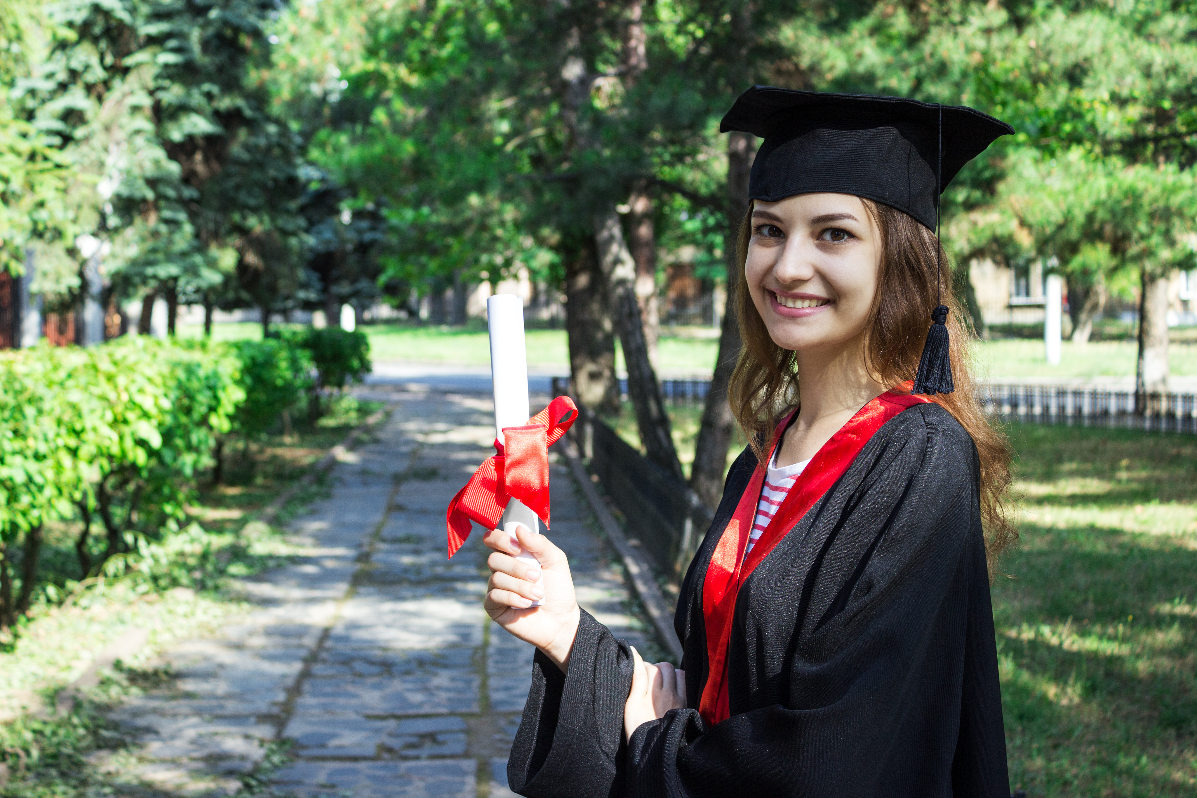 Graduate celebrating with diploma — certified career counsellor